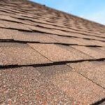 Explore the history of asphalt shingles from organic mats to fiberglass and eco-friendly recycled materials. Learn how roofing has evolved for durability and sustainability.
